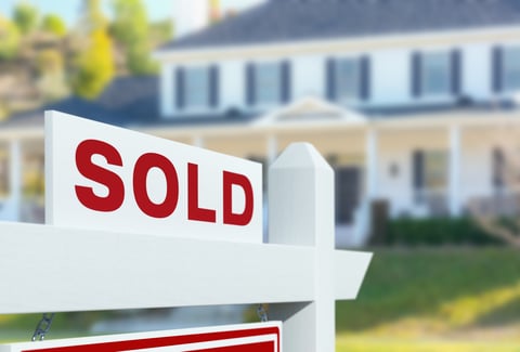 Sold real estate sign in front of new house